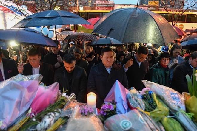 People bow their heads in silence at a vigil on Yonge Street in Toronto, Tuesday, April 24, 2018. Ten people were killed and 14 were injured in Monday’s deadly attack in which a van struck pedestrians in northern Toronto. THE CANADIAN PRESS/Galit Rodan