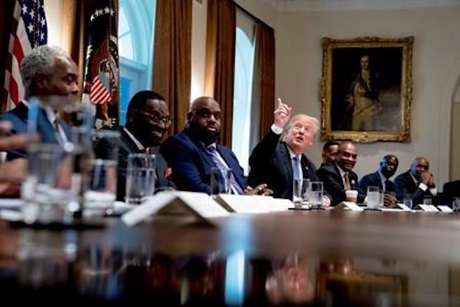 President Donald Trump points up to heaven as he speaks during a meeting with inner city pastors in the Cabinet Room of the White House in Washington, Wednesday, Aug. 1, 2018. (AP Photo/Andrew Harnik)